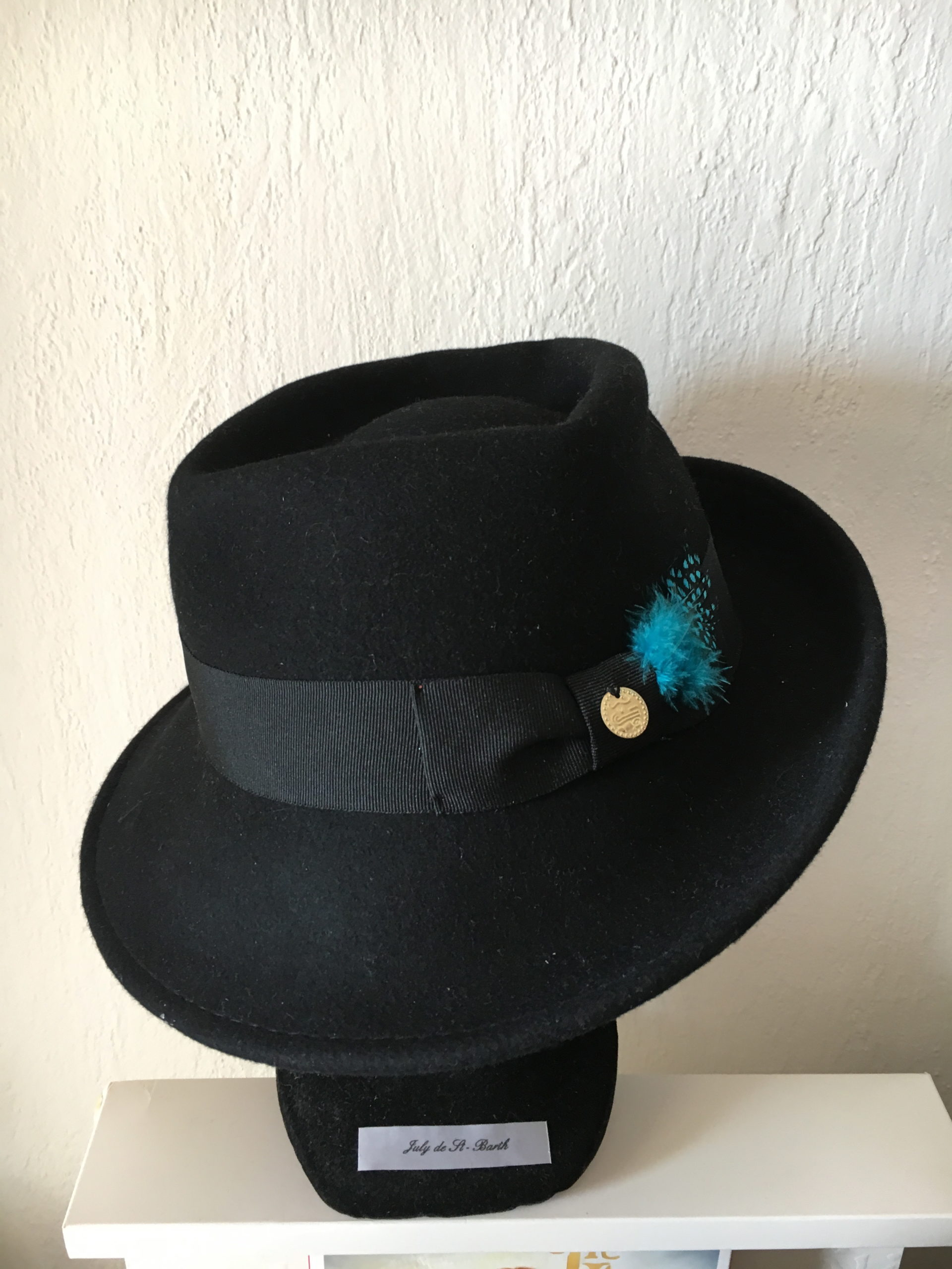 Black felt hat green feathers